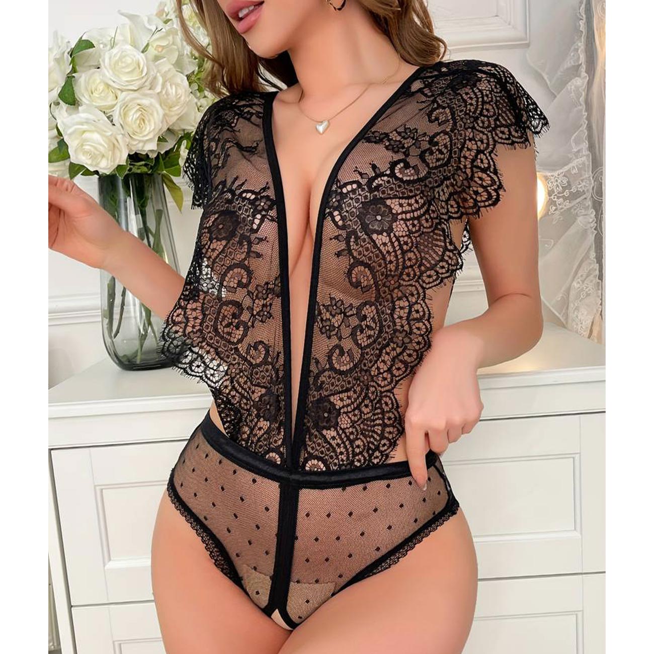 Discover allure with our Backless Lace Up Mesh Thong Bodysuit – Floral Lace Teddy Lingerie. This black lace lingerie, adorned with sheer lace and floral detailing, beautifully showcases your curves. The open back and crotchless teddy feature add an exciting touch to your intimate collection. Elevate your experience with something new today.