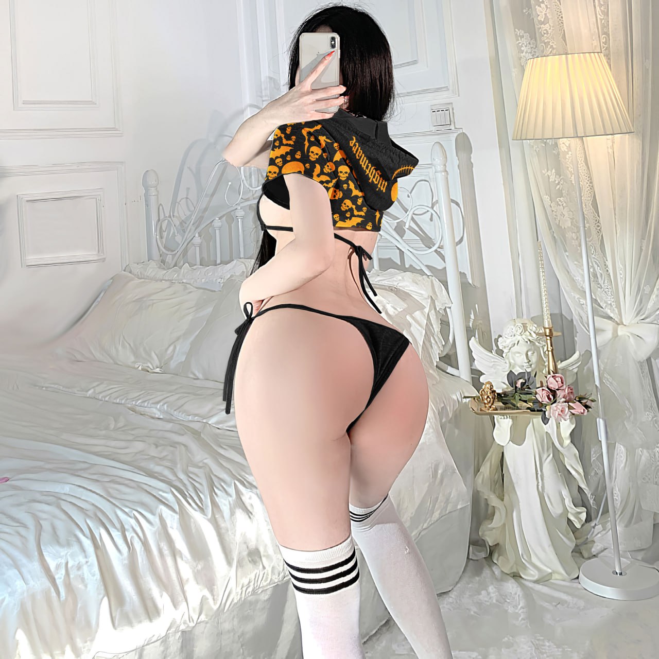 An alluring and seductive lingerie set with a gothic style, featuring intricate details and a unique print that makes it perfect for Halloween or any daring occasion. The set includes a top and bottom, both designed to fit perfectly and enhance the wearer's curves, making her feel confident and empowered.