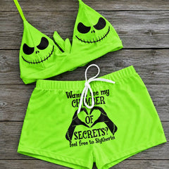 Wonder Skull sexy green two-piece string bikini for women, perfect for making a statement on the beach. The bikini features a halter V-neck, adjustable spaghetti straps, and removable soft padded cups for a flattering fit. Playful quote and Nightmare Before Christmas characters add a unique touch to this swimsuit. Stand out and have fun in this one-of-a-kind bathing suit.