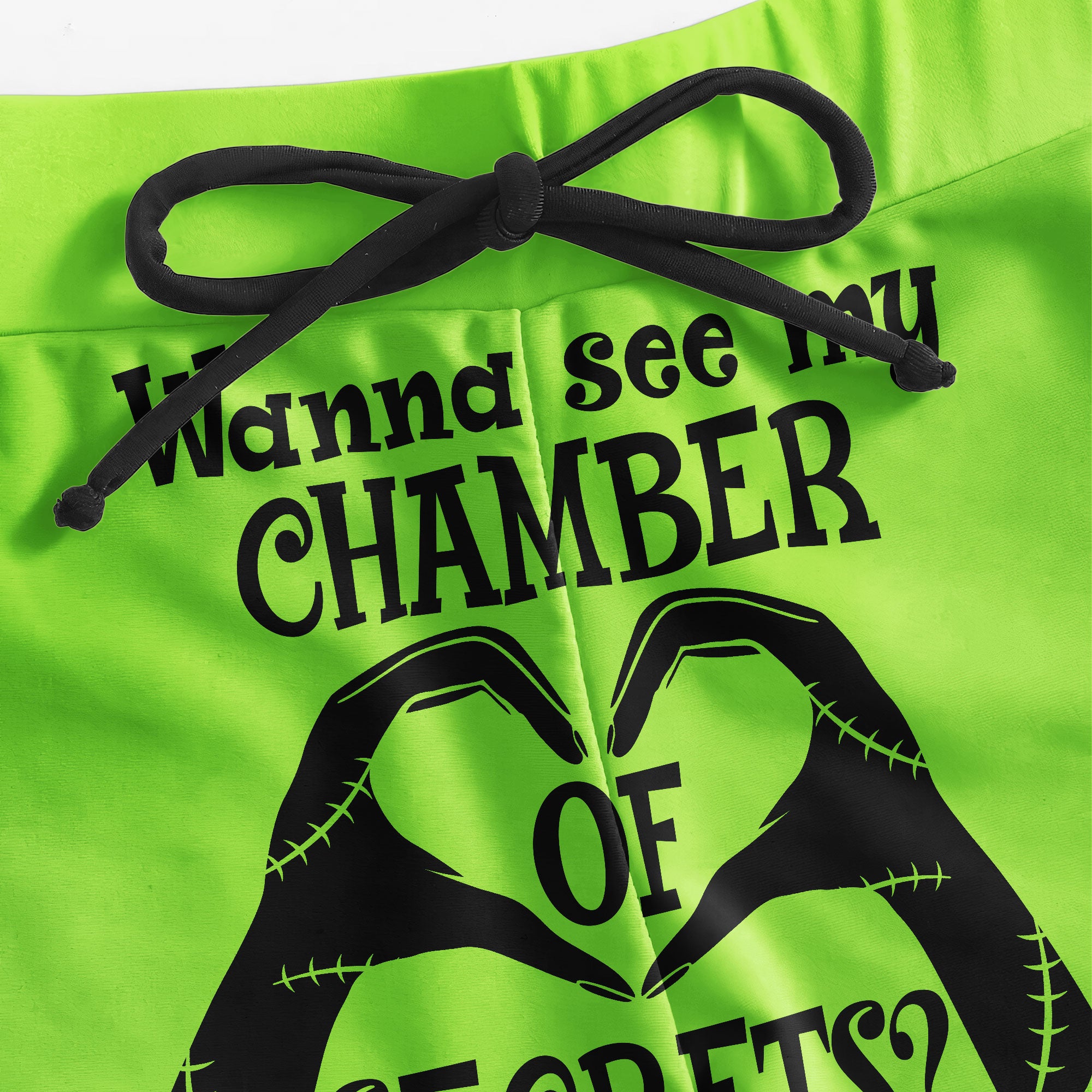 A sexy green two-piece string bikini for women, perfect for making a statement on the beach. The bikini features a halter V-neck, adjustable spaghetti straps, and removable soft padded cups for a flattering fit. Playful quote and Nightmare Before Christmas characters add a unique touch to this swimsuit. Stand out and have fun in this one-of-a-kind bathing suit.