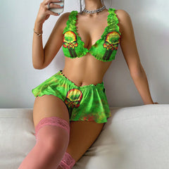 women's pajama set featuring a green skull art design. The top is adorned with ruffles, has good stretch, and a removable pad for comfortable wear all night long. The bottom part features a short cut with ruffles on the hem, allowing for a comfortable yet sexy look. Perfect for lounging or wearing out, just pair it with your favorite shirt. The vintage-inspired design adds a touch of retro charm to your wardrobe.