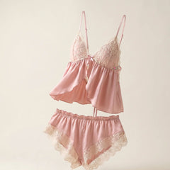 Wonder Skull blush pink satin babydoll set is made from buttery-smooth chiffon, making bedtime feel special. The delicate cream lace adds a romantic, non-scratchy touch. Its split-front design offers cool airflow and a beautiful drape, while adjustable straps and a tie-back closure ensure a custom fit. The set includes matching shorts with floral lace trim for a complete look. Whether sleeping or lounging, this set combines femininity and comfort.