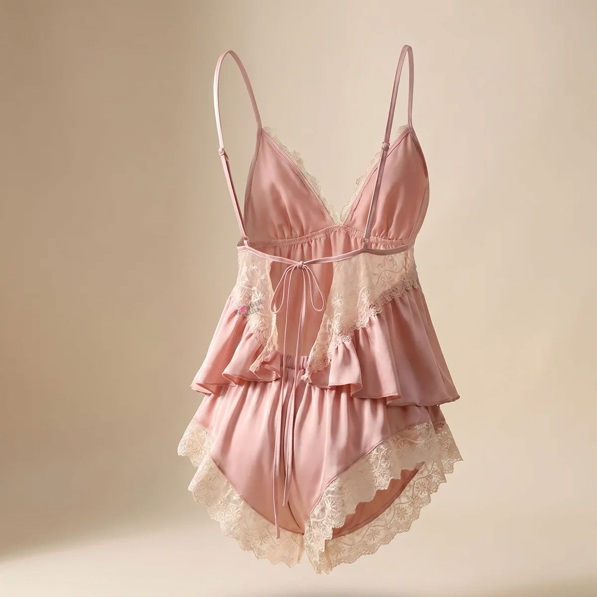 Wonder Skull blush pink satin babydoll set is made from buttery-smooth chiffon, making bedtime feel special. The delicate cream lace adds a romantic, non-scratchy touch. Its split-front design offers cool airflow and a beautiful drape, while adjustable straps and a tie-back closure ensure a custom fit. The set includes matching shorts with floral lace trim for a complete look. Whether sleeping or lounging, this set combines femininity and comfort.
