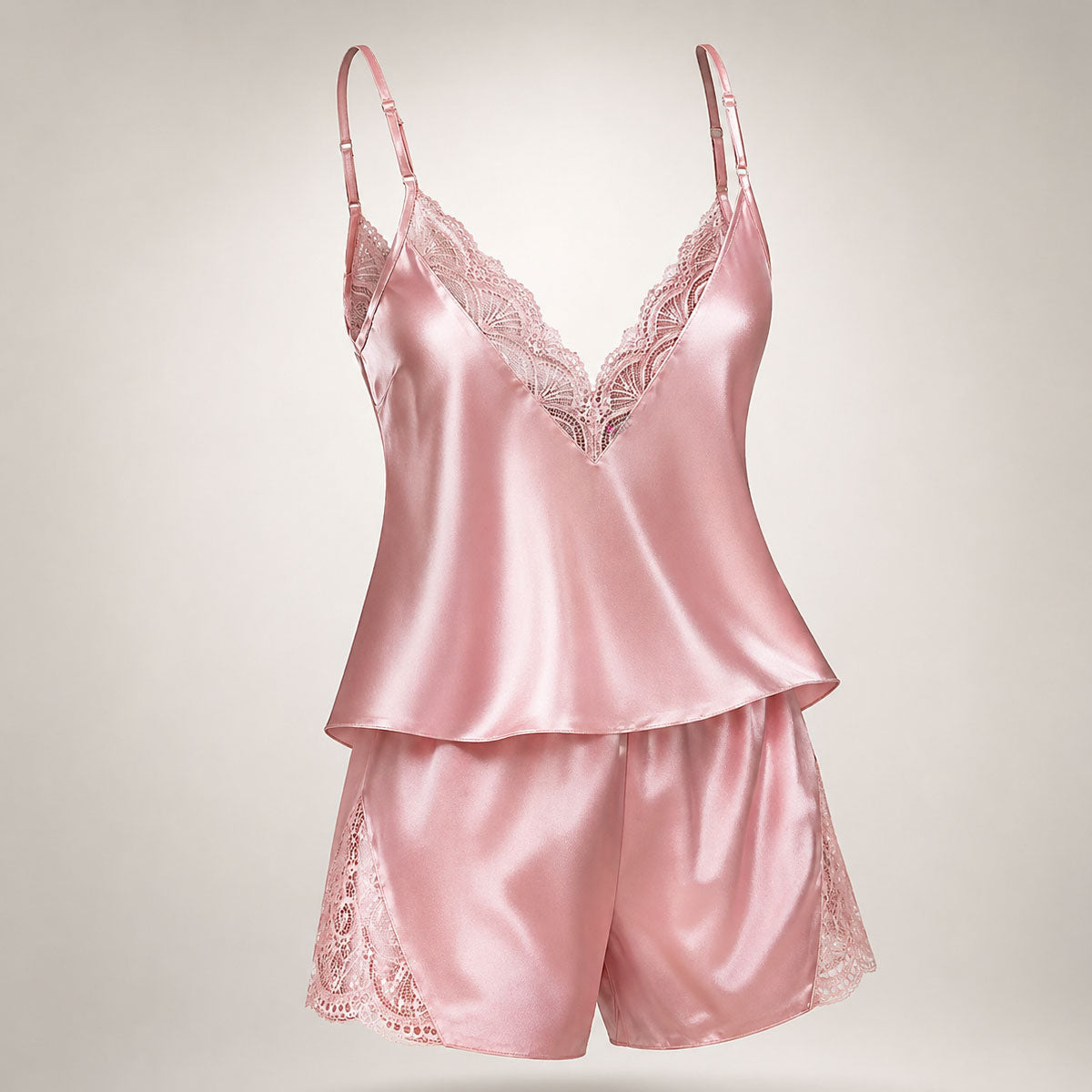 Upgrade your sleepwear with the Wonder Skull Dusty Pink Satin Lace Pajama Set. This two-piece set is made from a buttery-soft satin that feels amazing against your skin and is trimmed with delicate eyelash lace for a romantic touch. The V-back design keeps you cool, while adjustable spaghetti straps ensure a perfect fit. This matching set will make you feel beautiful, whether you're sleeping soundly or enjoying a lazy morning.