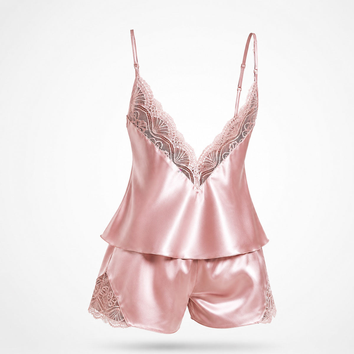 Upgrade your sleepwear with the Wonder Skull Dusty Pink Satin Lace Pajama Set. This two-piece set is made from a buttery-soft satin that feels amazing against your skin and is trimmed with delicate eyelash lace for a romantic touch. The V-back design keeps you cool, while adjustable spaghetti straps ensure a perfect fit. This matching set will make you feel beautiful, whether you're sleeping soundly or enjoying a lazy morning.