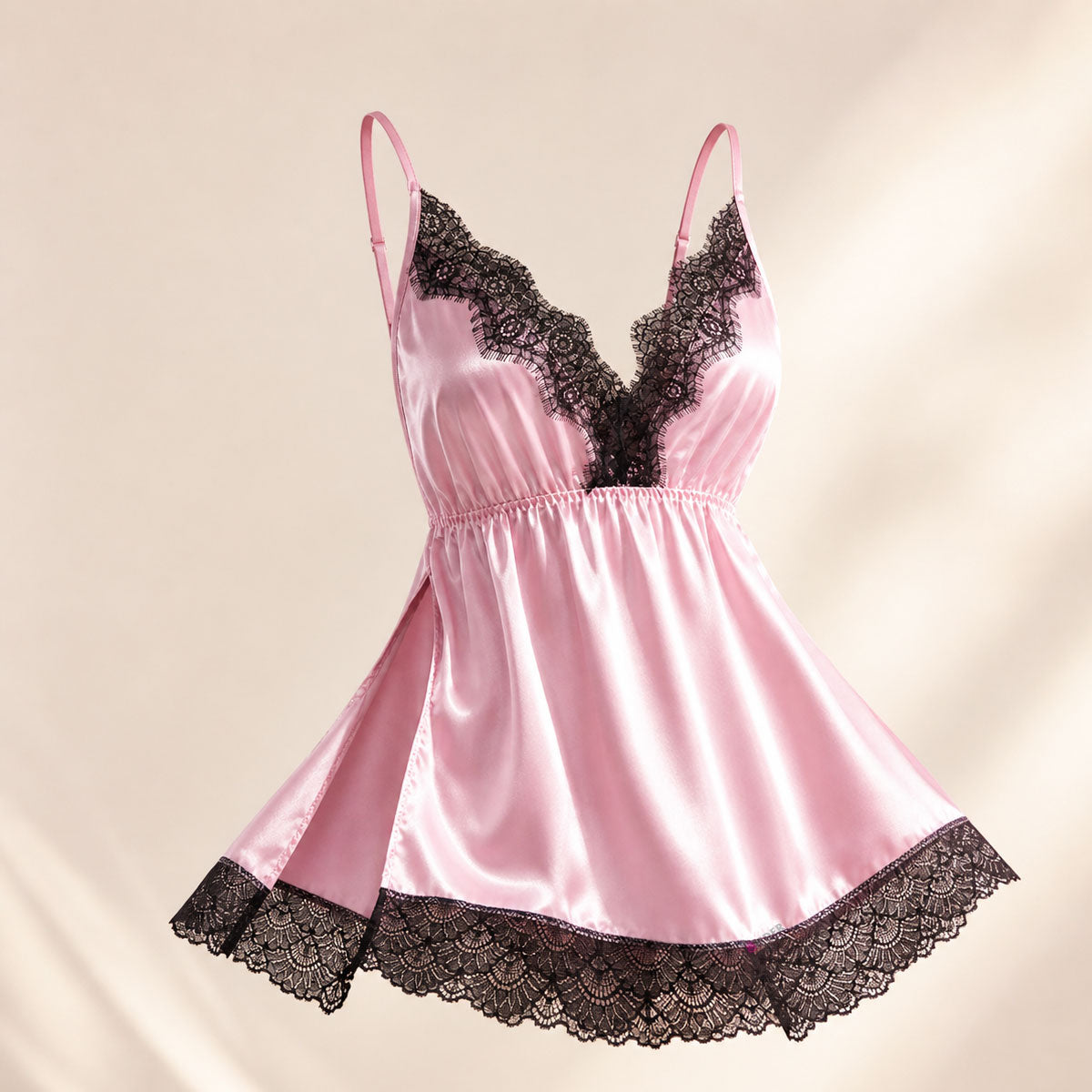 Make your nighttime routine beautiful with the Wonder Skull Pink Black Lace Chemise. Its buttery-smooth satin glides against your skin, and the elastic cinched waist flatters your shape. Adjustable criss-cross back straps stay in place and customize the fit. Delicate, soft scalloped eyelash lace adds a romantic contrast at the neckline and hem. Plus, side slits allow for easy movement, so you can wake up comfortable and tangle-free.