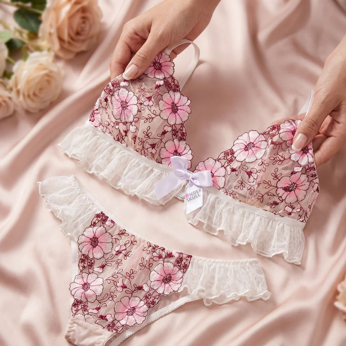 Wonder Skull Pink Floral Lace Embroidered Ruffle Bralette and Panty Set offers a feminine look without uncomfortable squeezing or digging. Its wire-free, soft cup design and breathable mesh fabric allow for natural movement while keeping you cool. The smooth floral embroidery adds a touch of romance without causing irritation. Adjustable straps and a hook-and-eye closure ensure a custom, secure fit. Finished with sweet white ruffle trim and satin bows, this set is designed to make you feel both beautiful an
