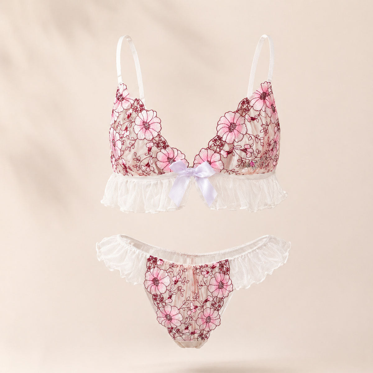 Wonder Skull Pink Floral Lace Embroidered Ruffle Bralette and Panty Set offers a feminine look without uncomfortable squeezing or digging. Its wire-free, soft cup design and breathable mesh fabric allow for natural movement while keeping you cool. The smooth floral embroidery adds a touch of romance without causing irritation. Adjustable straps and a hook-and-eye closure ensure a custom, secure fit. Finished with sweet white ruffle trim and satin bows, this set is designed to make you feel both beautiful an