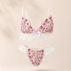 Wonder Skull Pink Floral Lace Embroidered Ruffle Bralette and Panty Set offers a feminine look without uncomfortable squeezing or digging. Its wire-free, soft cup design and breathable mesh fabric allow for natural movement while keeping you cool. The smooth floral embroidery adds a touch of romance without causing irritation. Adjustable straps and a hook-and-eye closure ensure a custom, secure fit. Finished with sweet white ruffle trim and satin bows, this set is designed to make you feel both beautiful an
