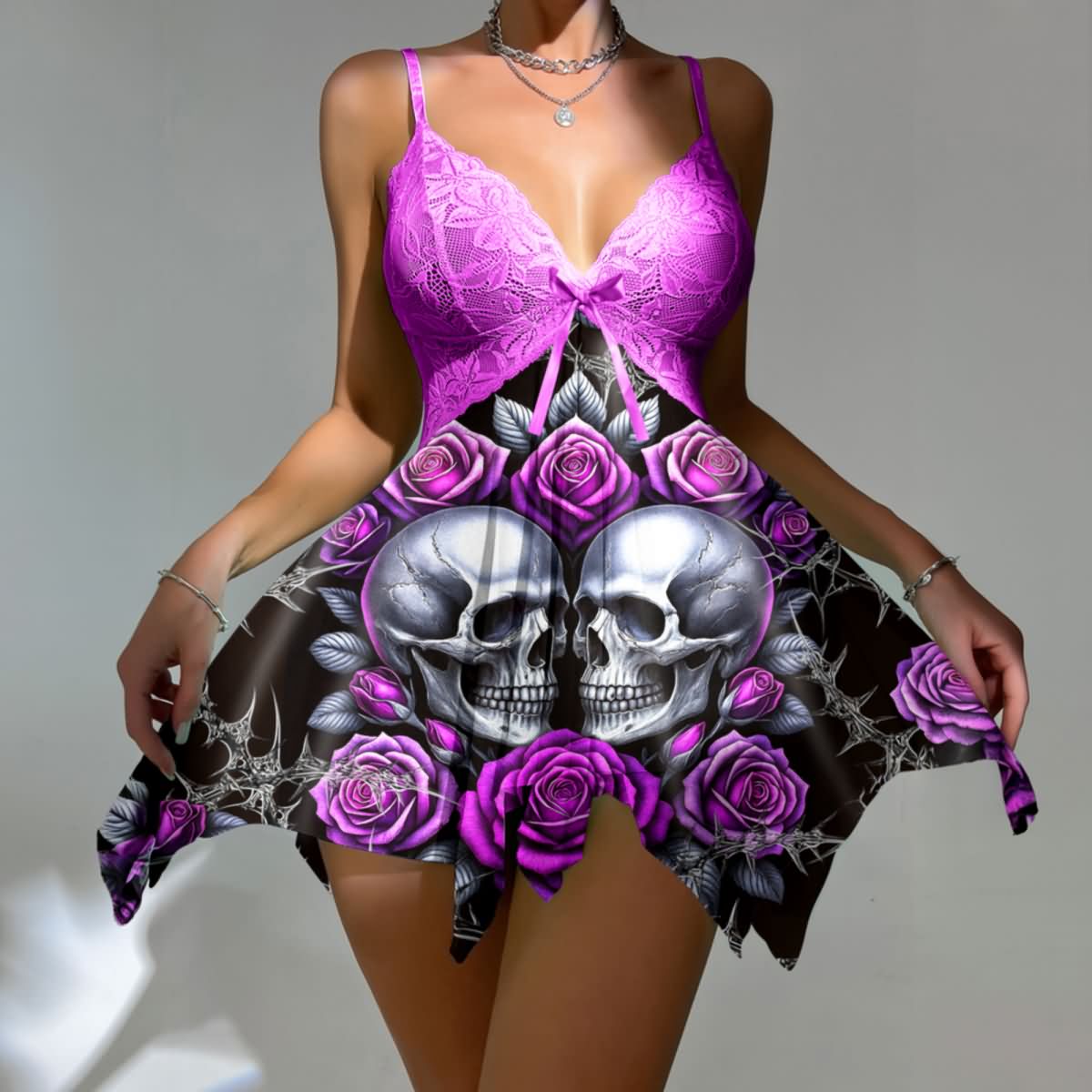Wonder Skull Purple Roses Skull Lace Nightgown Babydoll Sleepwear Set combines sweet and edgy details with silver skull accents, rose patterns, and a playful satin bow. Made from lightweight fabric with a jagged hem for a daring vibe, it comes with a matching thong for a complete, confident look. Perfect for those who love romantic yet rebellious styles.