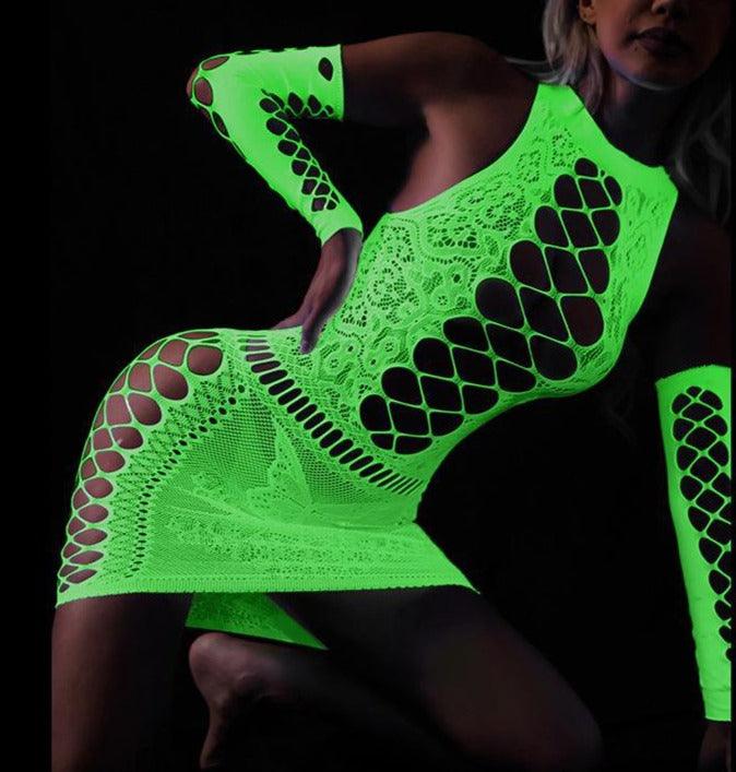 A close-up image of a woman wearing a Sexy Glowing Fishnet Bodysuit Tights. The fishnet tights are intricately woven and glow in the dark, adding a unique and alluring element to the lingerie. The bodysuit is form-fitting and accentuates the curves of the woman's body. She stands confidently, with her hands on her hips, and looks directly at the camera.
