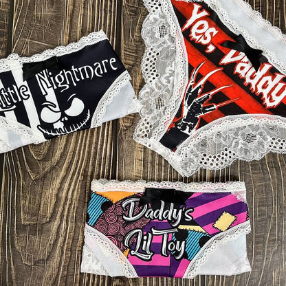 Wonder Skull Sinful Strings Lace Panty Set is for those who love mixing sweet with sassy. The white lace contrasts with bold gothic graphics and cheeky sayings, creating underwear that's both innocent and playful. Designed to make you feel confident and unstoppable, this set is perfect for treating yourself or planning a fun surprise. Comfort and attitude, all in one.
