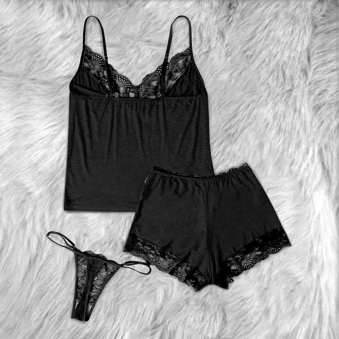 Transform your nighttime routine with the Wonder Skull glow-in-the-dark sleepwear set. The vibrant rainbow skull graphics absorb light by day and glow when darkness falls. Made from a buttery-soft, breathable fabric, this set keeps you cool all night. The delicate, dotted lace trim adds a feminine touch without being scratchy, while adjustable spaghetti straps ensure a perfect fit. This three-piece set includes a matching cami, shorts, and thong, letting you express your bold personality in comfort.