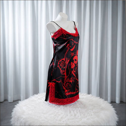 Experience better sleep with the Wonder Skull Chemise Nightgown. Its buttery-soft satin feels amazing, while red lace panels at the neckline, sides, and hem keep you cool all night. The adjustable straps and flowing A-line silhouette allow for a comfortable, non-restrictive fit. Bold red crackle skeleton artwork is balanced by sweet satin bows, adding a feminine touch. 