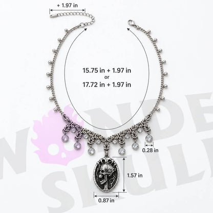 A gothic day collar featuring a silver-tone chain, cracked black-and-silver skull centerpiece, and clear faceted accents. Available in two lengths with a 1.97-inch extension and secured with a lobster clasp.