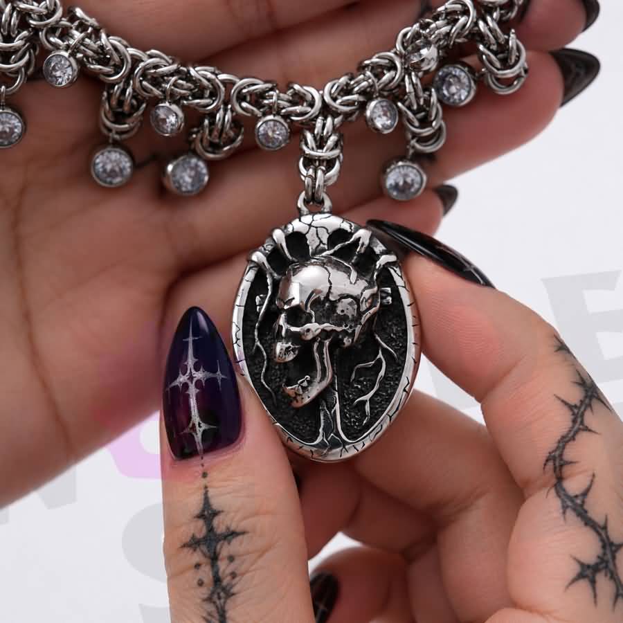 A gothic day collar featuring a silver-tone chain, cracked black-and-silver skull centerpiece, and clear faceted accents. Available in two lengths with a 1.97-inch extension and secured with a lobster clasp.