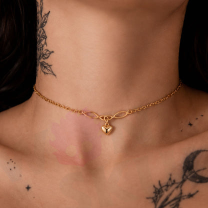 Wonder Skull Gold Heart Charm Day Collar Stainless Steel Sub Necklace. A quiet promise for everyday wear. A dainty gold-tone chain connects a Celtic-style twist to a puffed heart charm—a discreet symbol only the two of you understand. Built for 24/7 wear, it's waterproof, tarnish-free, and hypoallergenic. Available in 16" or 18", it looks like everyday jewelry but means too much to ever take off. Devotion you wear. Strength you keep.