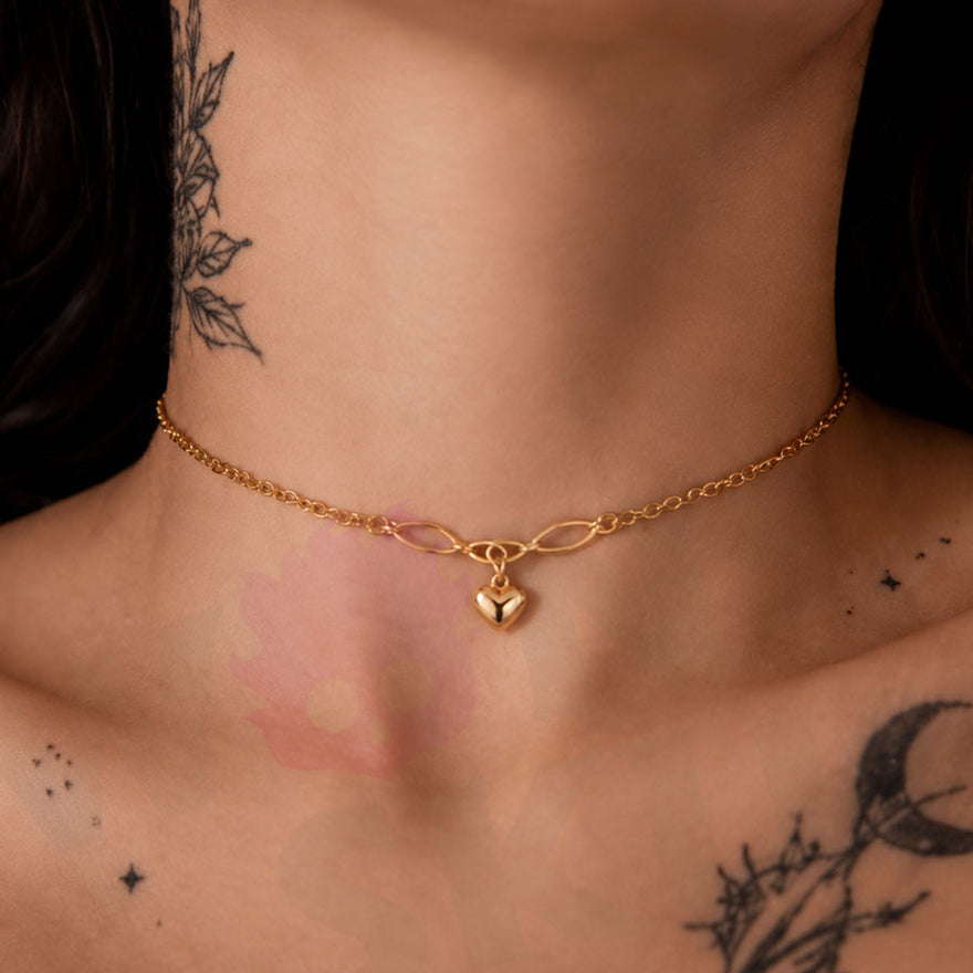 Wonder Skull Gold Heart Charm Day Collar Stainless Steel Sub Necklace. A quiet promise for everyday wear. A dainty gold-tone chain connects a Celtic-style twist to a puffed heart charm—a discreet symbol only the two of you understand. Built for 24/7 wear, it's waterproof, tarnish-free, and hypoallergenic. Available in 16" or 18", it looks like everyday jewelry but means too much to ever take off. Devotion you wear. Strength you keep.