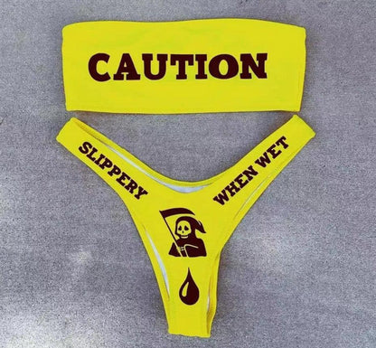 Make a splash with the Wonder Skull Neon Yellow Caution Tape Bikini Set. This bold bandeau top features a grippy lining to stay secure, while the stretchy, quick-dry fabric ensures all-day comfort. With daring caution tape and skull graphics, this supportive two-piece set is perfect for making a statement by the pool.