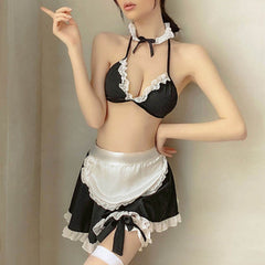 Wonder Skull Obey Me Softly Maid Cosplay Cheeky Spicy Lace Lingerie Set combines flirty, feminine details with sultry vibes. Featuring a ruffled triangle bra, a satin apron with a flared skirt, and playful touches like oversized ribbons and thigh-high bows, it’s perfect for roleplay or adding fun to your intimate wardrobe. Adjustable ties ensure a comfortable, custom fit for unforgettable moments.