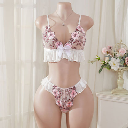 Wonder Skull Pink Floral Lace Embroidered Ruffle Bralette and Panty Set offers a feminine look without uncomfortable squeezing or digging. Its wire-free, soft cup design and breathable mesh fabric allow for natural movement while keeping you cool. The smooth floral embroidery adds a touch of romance without causing irritation. Adjustable straps and a hook-and-eye closure ensure a custom, secure fit. Finished with sweet white ruffle trim and satin bows, this set is designed to make you feel both beautiful an