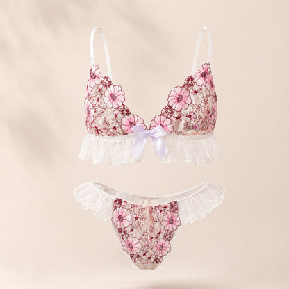 Wonder Skull Pink Floral Lace Embroidered Ruffle Bralette and Panty Set offers a feminine look without uncomfortable squeezing or digging. Its wire-free, soft cup design and breathable mesh fabric allow for natural movement while keeping you cool. The smooth floral embroidery adds a touch of romance without causing irritation. Adjustable straps and a hook-and-eye closure ensure a custom, secure fit. Finished with sweet white ruffle trim and satin bows, this set is designed to make you feel both beautiful an