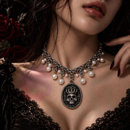 Wonder Skull Queen Pearl Chain Statement Necklace features a crowned skull pendant with silver-tone chainwork and faux-pearl accents. Its layered collar design blends dark romance with vintage glamour, making it perfect for gothic, alternative, or special occasion looks.
