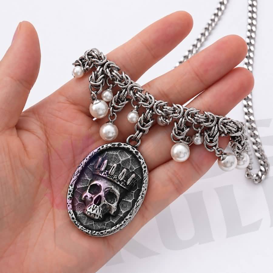 Wonder Skull Queen Pearl Chain Statement Necklace features a crowned skull pendant with silver-tone chainwork and faux-pearl accents. Its layered collar design blends dark romance with vintage glamour, making it perfect for gothic, alternative, or special occasion looks.