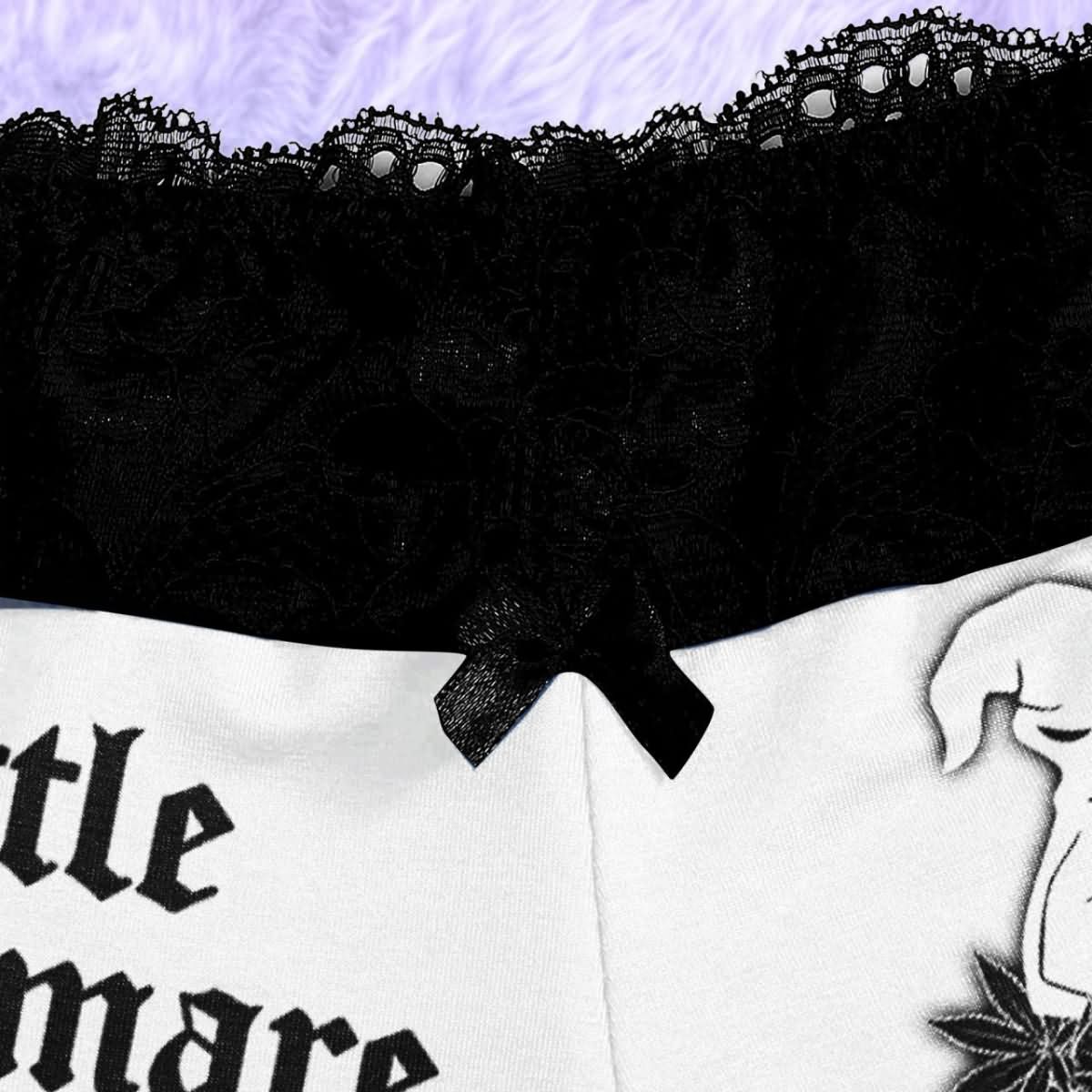 Wonder Skull White Lightning 3-Piece Gothic Sleepwear Set blends edgy design with elegant details. This set includes a white cami adorned with a bold lightning print, Gothic-inspired pajama shorts with stylish lettering, and delicate black lace accents. A coordinating thong completes the look, making it an ideal choice for those who appreciate loungewear that’s equal parts artistic, fashionable, and comfortable.