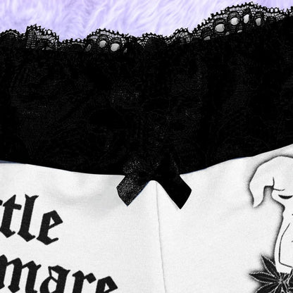 Wonder Skull White Lightning 3-Piece Gothic Sleepwear Set blends edgy design with elegant details. This set includes a white cami adorned with a bold lightning print, Gothic-inspired pajama shorts with stylish lettering, and delicate black lace accents. A coordinating thong completes the look, making it an ideal choice for those who appreciate loungewear that’s equal parts artistic, fashionable, and comfortable.