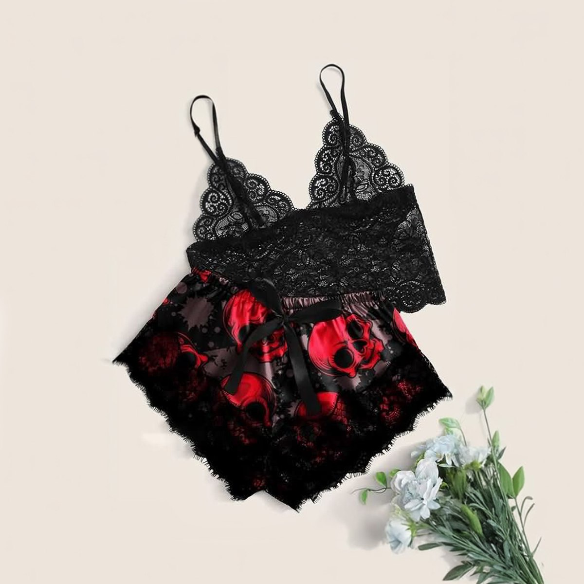 Wonder Skull sleepwear set combines comfort and bold style. The black floral lace trim on the cami and shorts feels soft on your skin, while lightweight, breathable fabric keeps you cool all night. Adjustable straps ensure a perfect fit, and the red skull print adds an edgy, confident touch.