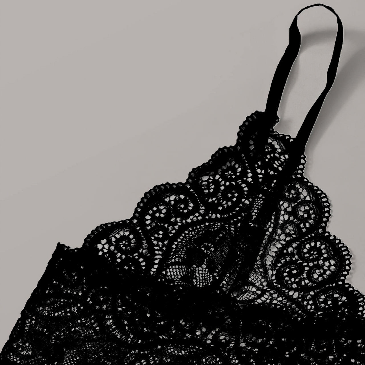 A gothic lingerie set featuring a red skull design on a black lace background.