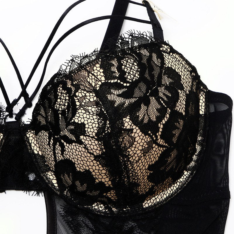 Welcome to the world of allure and elegance with the Nightmare Bandage Women's Bodysuit Sexy Hollow Lace Push Up. 